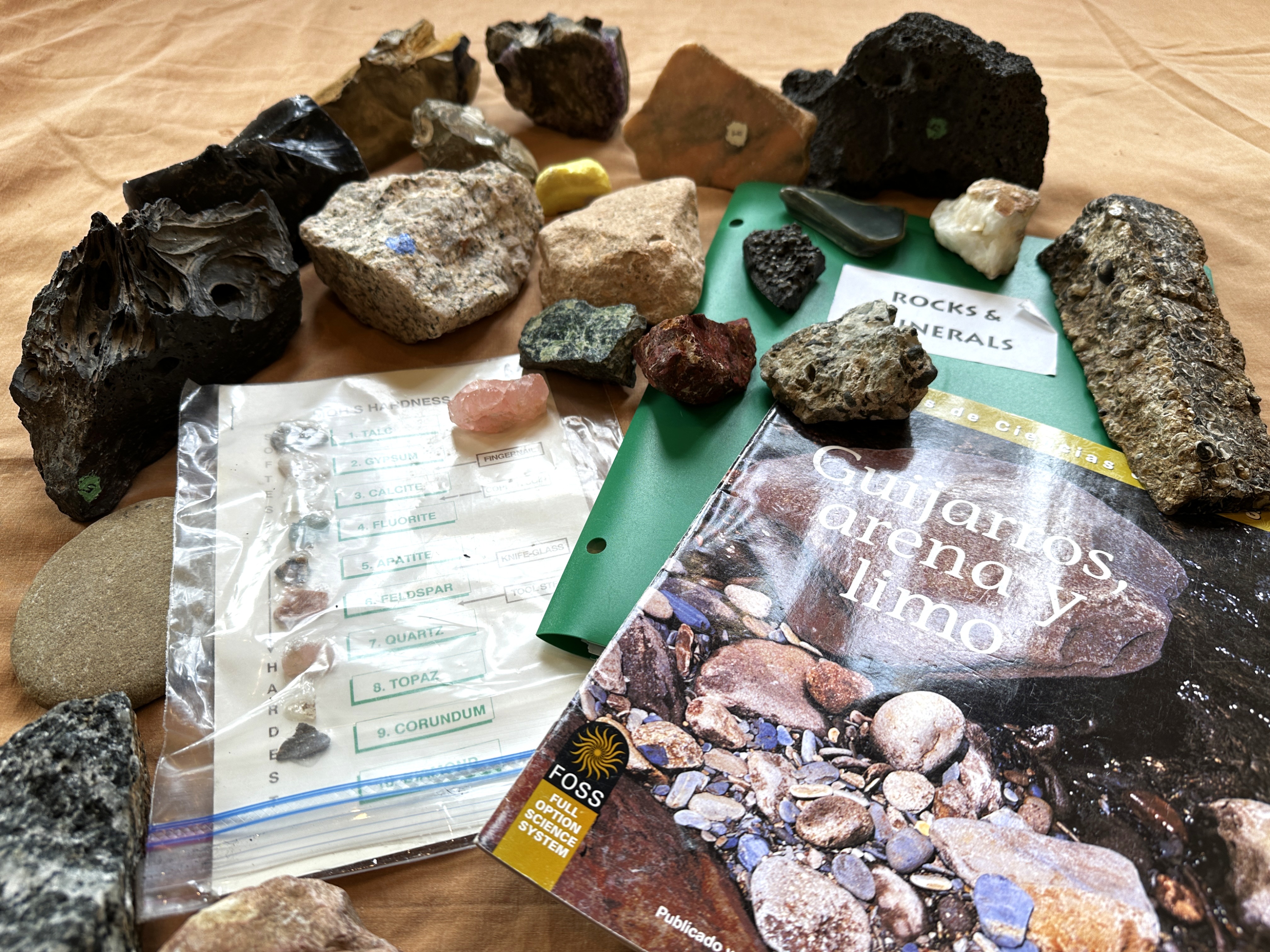 A display of rocks and minerals on top of manuscripts.