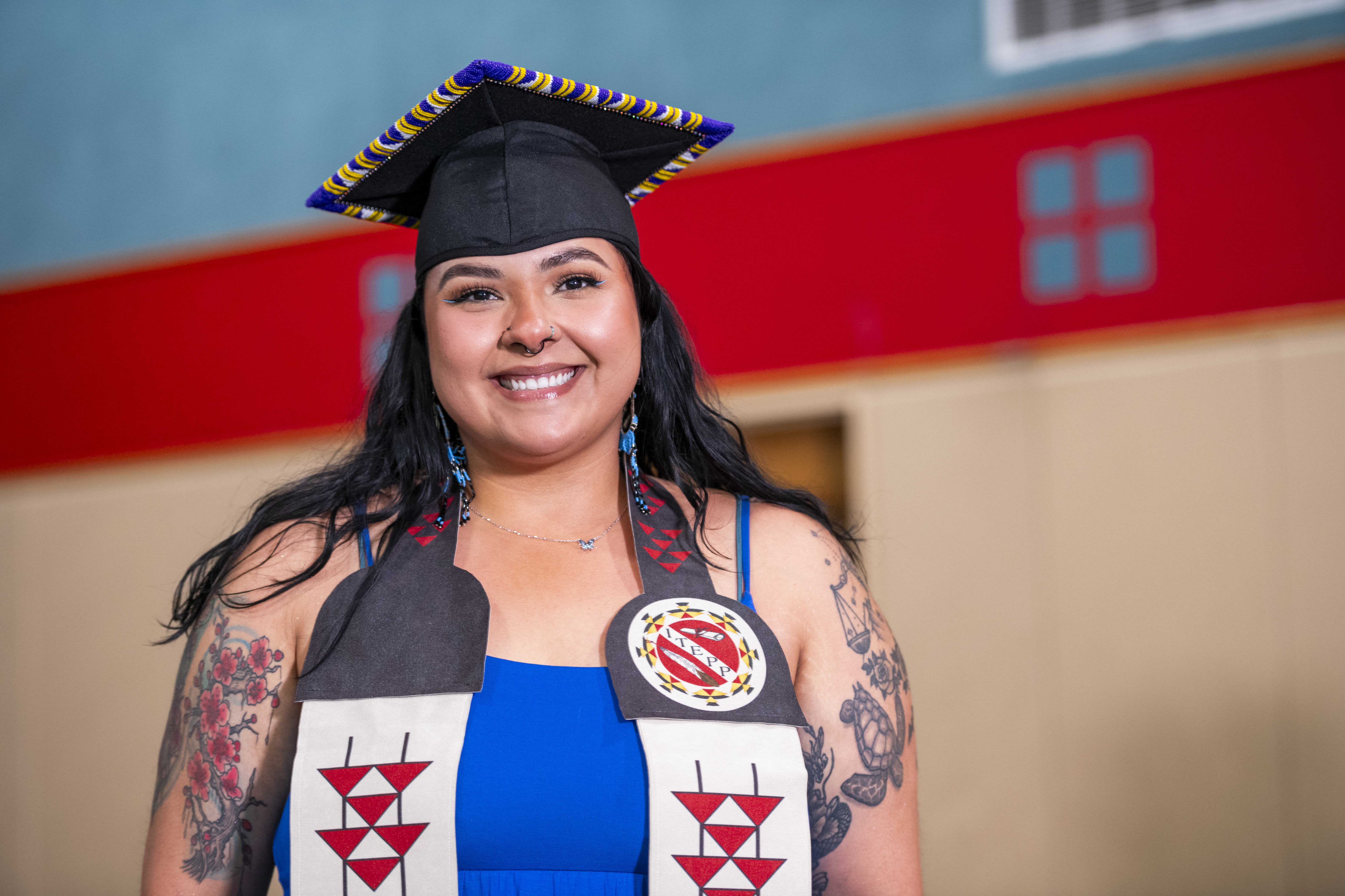 A native grad with her ITEPP grad sash on. 