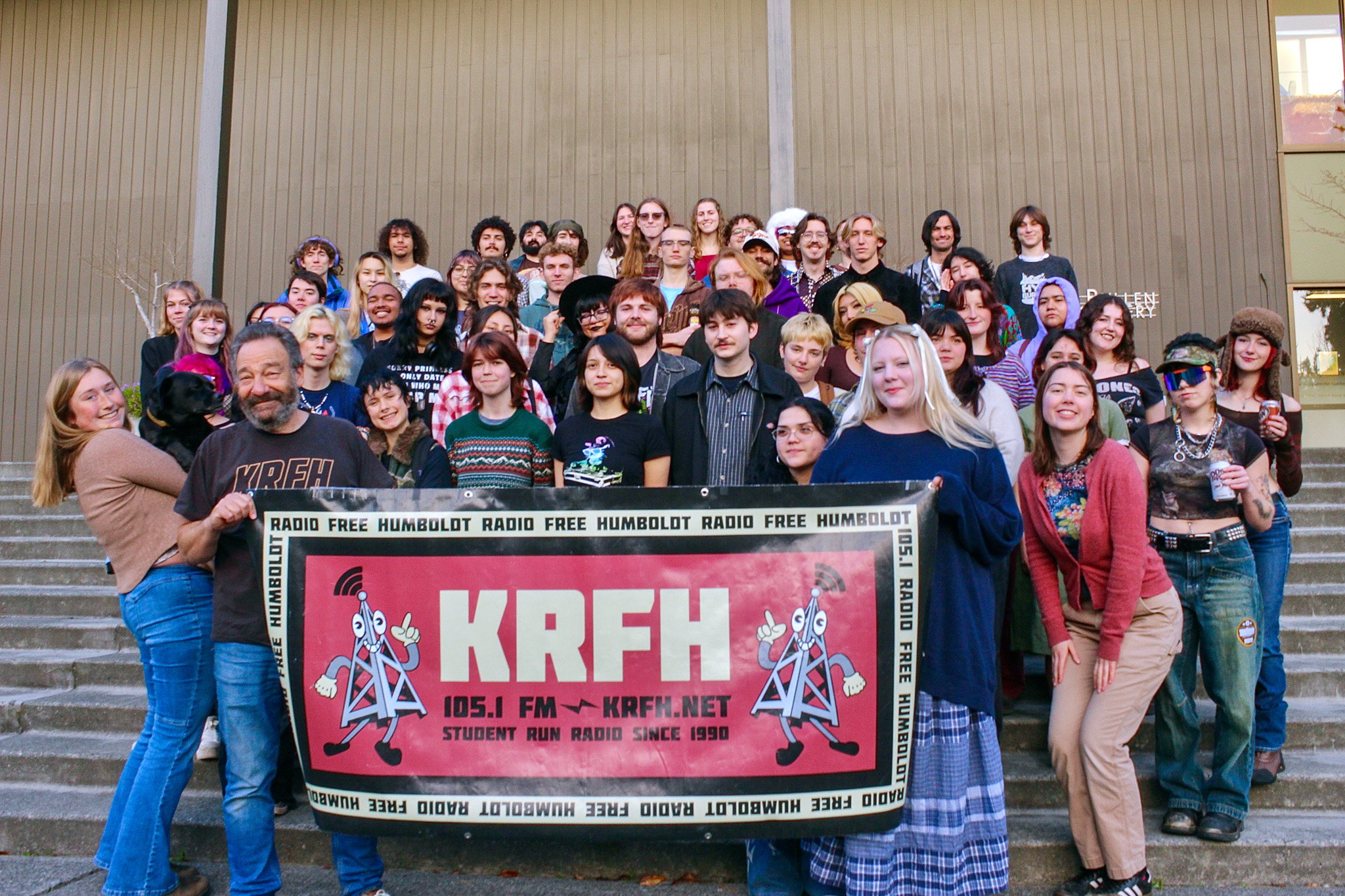 A group photo of more than 40 KRFH radio students on a set of outside stairs.