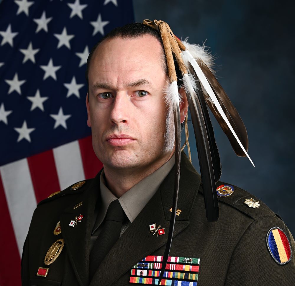 A portrait of Major Patrick Sorensen wearing his Native American regalia while wearing a U.S. Army uniform