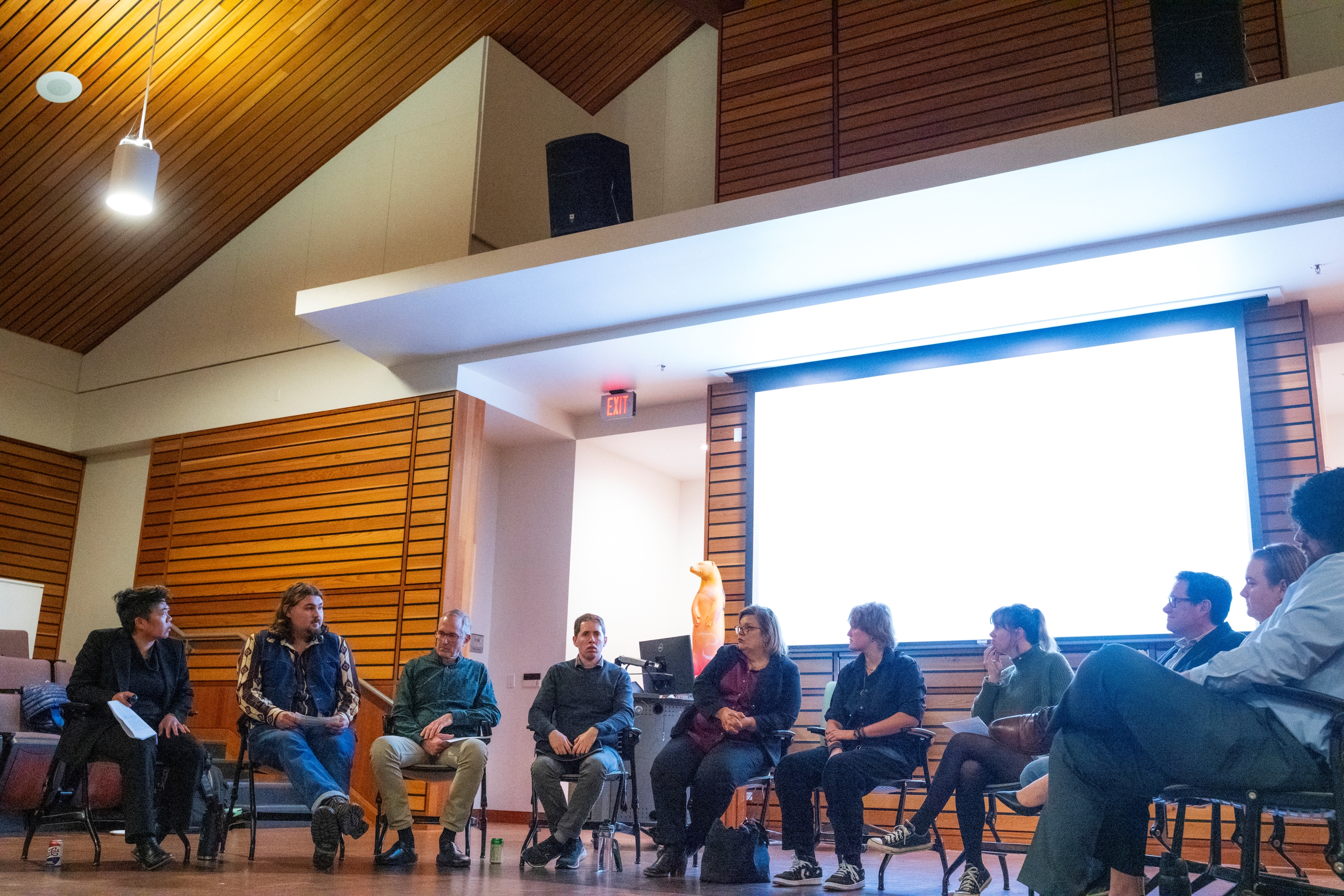 Politics students and faculty discussing topics in a forum.