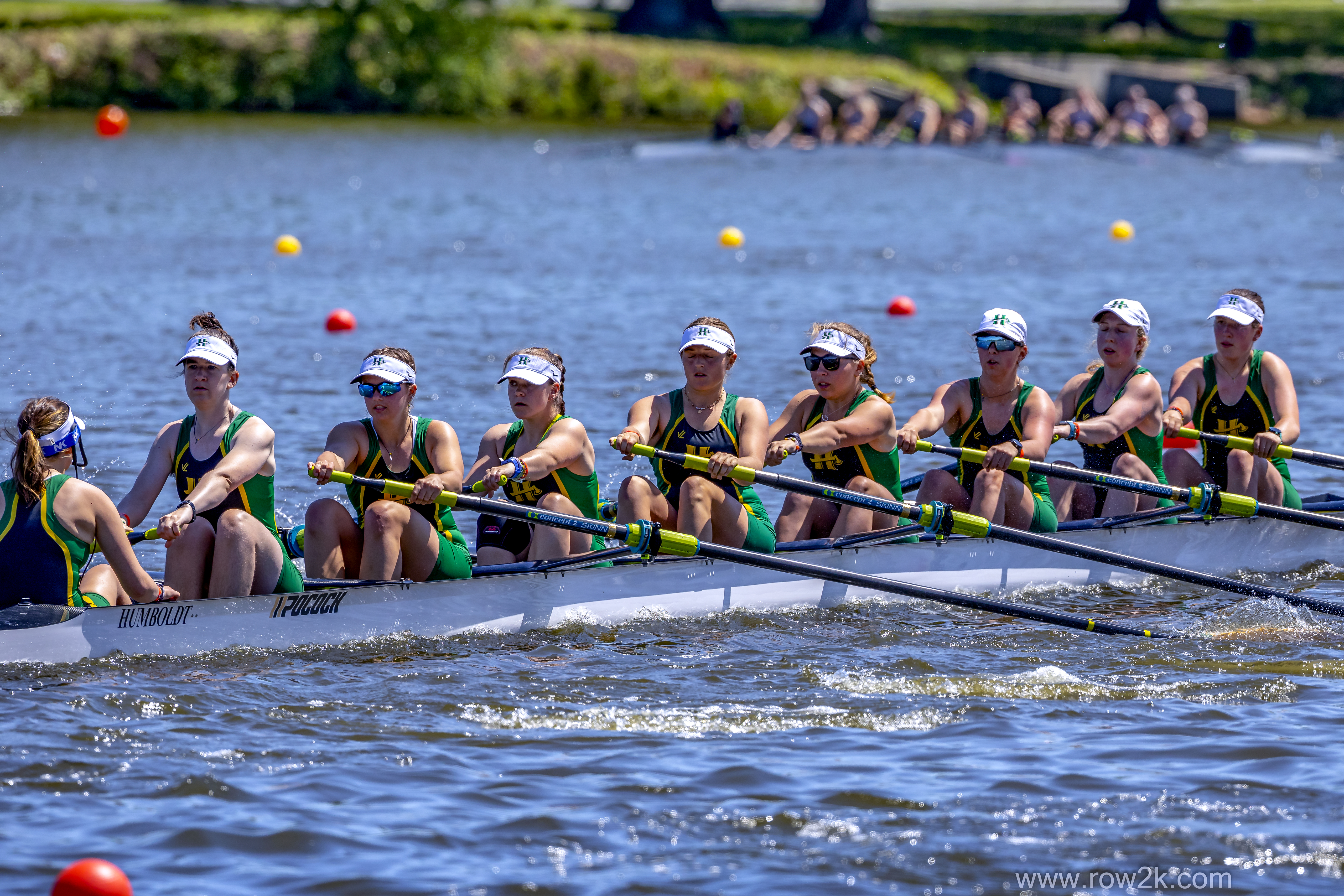 women's crew team in the 8 person boat, rowing.