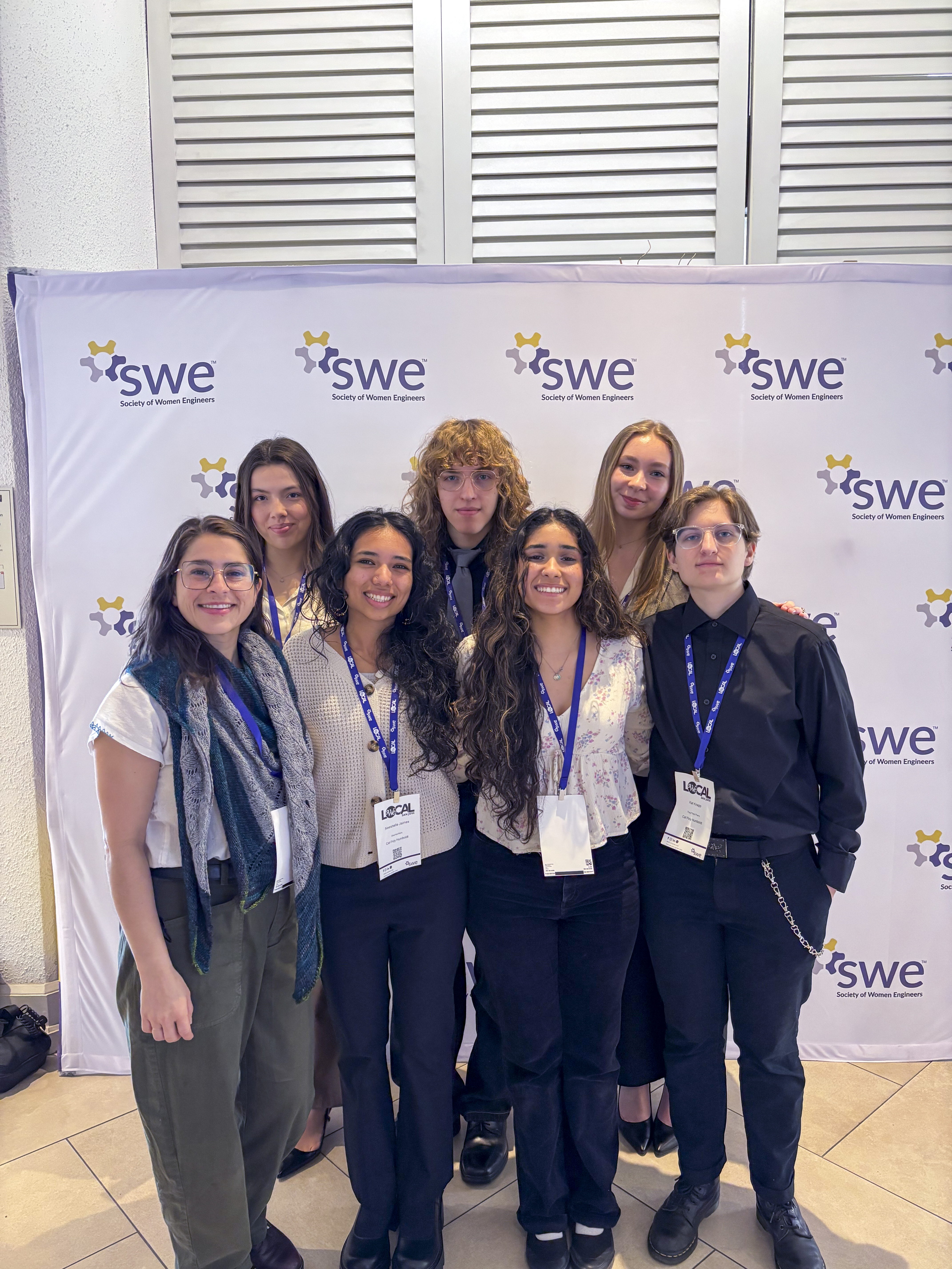 A group photo of women engineers at a conference in professional clothing.