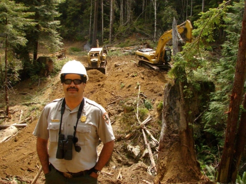 A photo of Leonel Arguello in front of active restoration efforts in Larry Dam Creek circa 2006. 