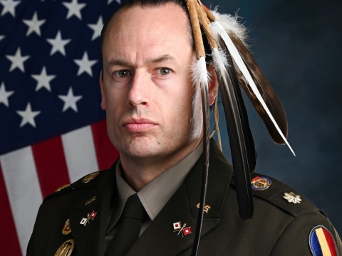 A portrait of Major Patrick Sorensen wearing his Native American regalia while wearing a U.S. Army uniform